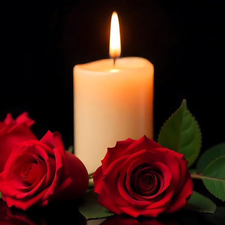 A red rose with candles and a red rose in the background