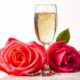 Valentine’s day roses and champagne wine isolated on white — Photo
