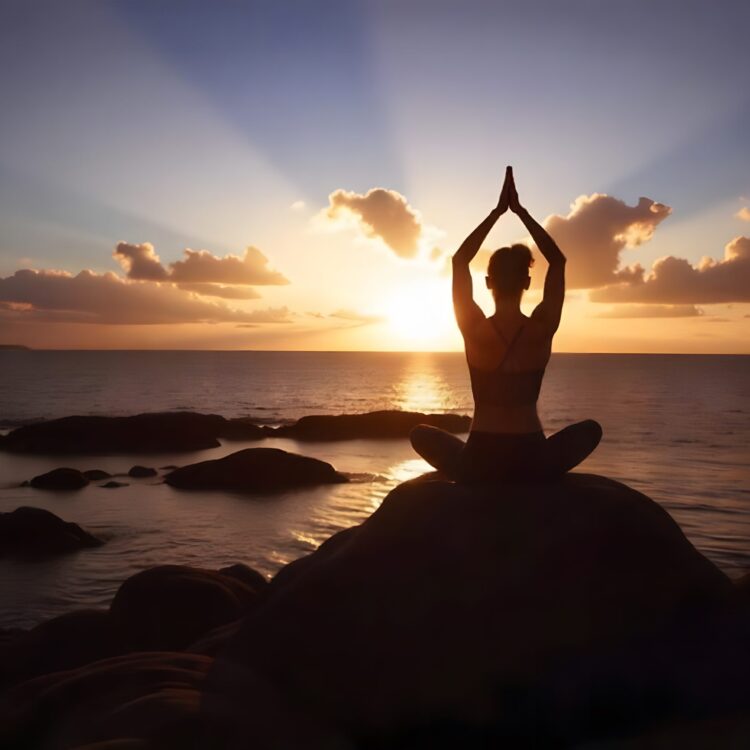 Silhouette Of A Person Meditating On A Mountain Top At Sunset